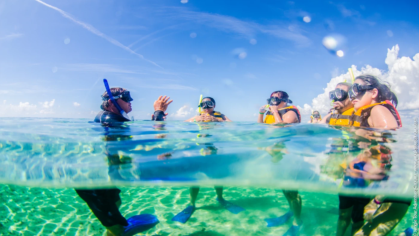The jungle tour adventure guide gives instructions to his guests at Punta Nizuc Reef before swimming.